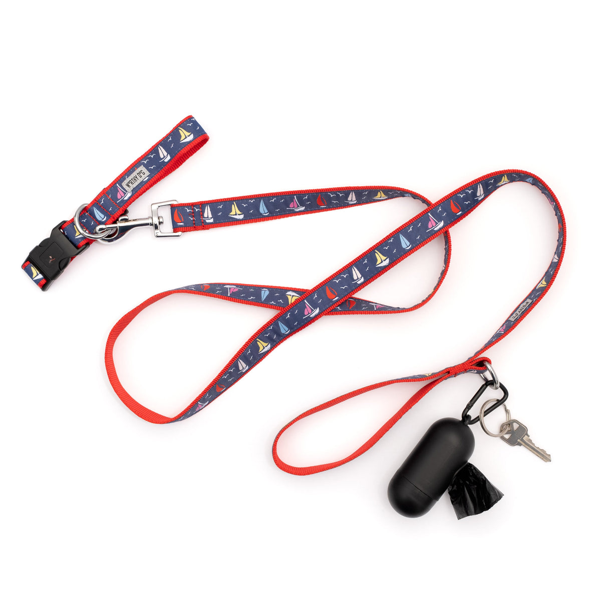 Repeating sailboat illustrations on navy ribbon nylon dog leash, shown with matching accessories; accessories not included