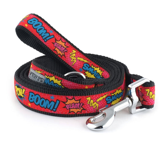 Colorful comic-book lettering and burst shapes on red nylon dog leash, coiled