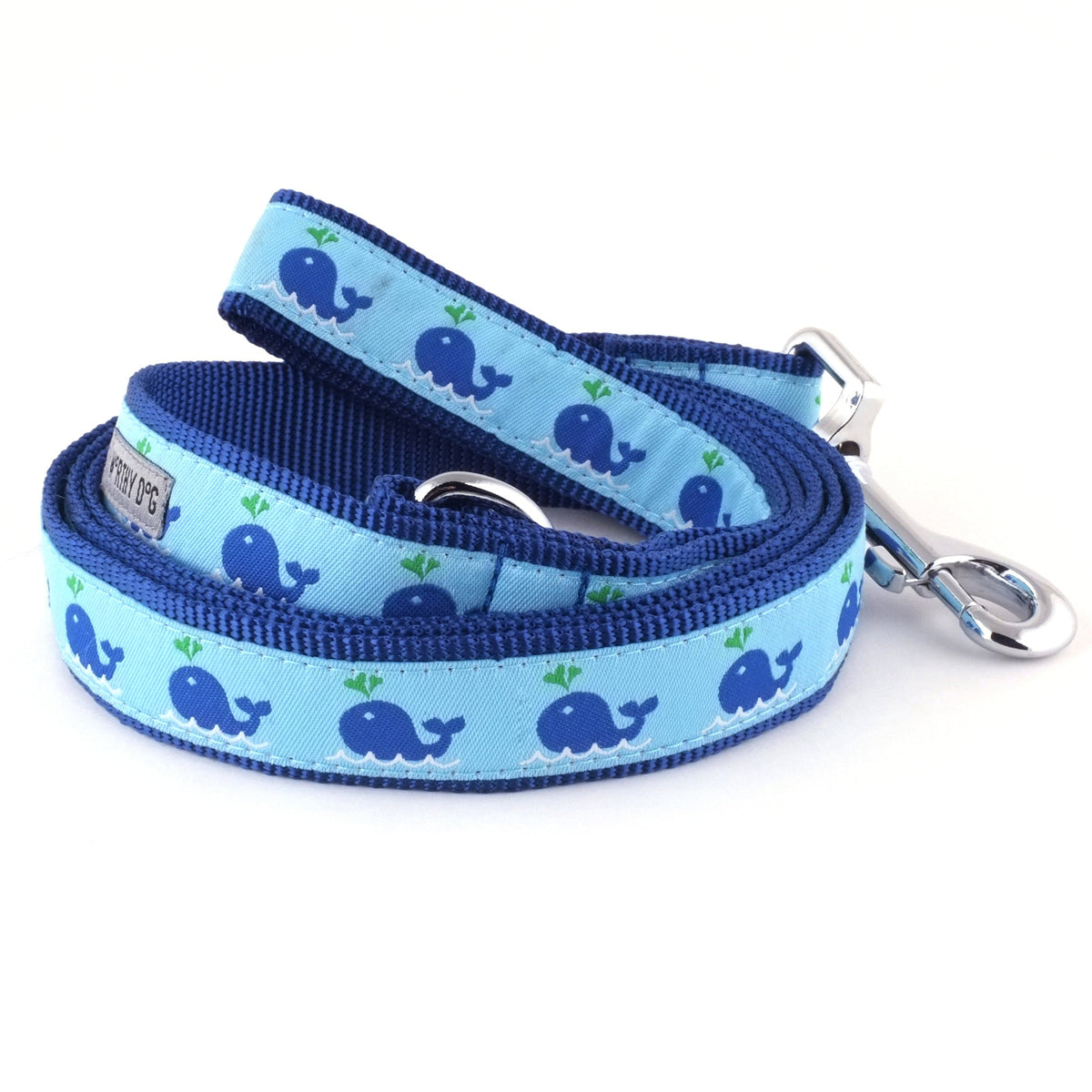 Dark blue whales with water spouts on light blue ribbon nylon dog leash, coiled