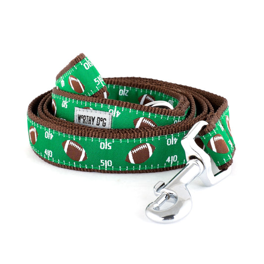 Footballs and numbered field markings on green ribbon nylon dog leash, coiled