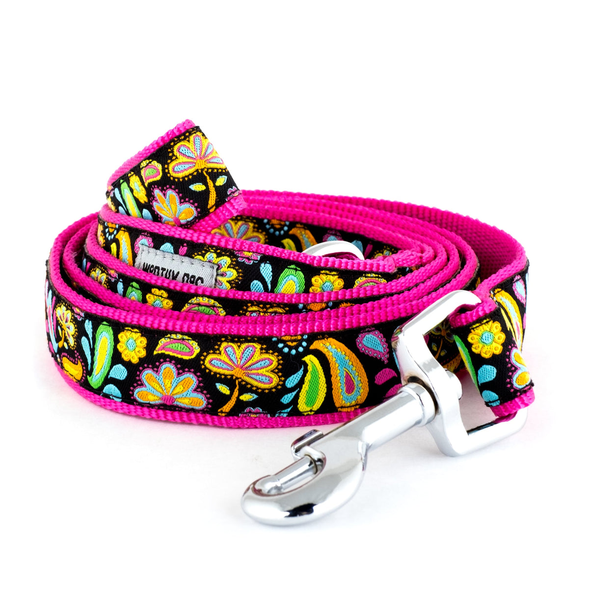 Colorful floral and paisley shapes on black ribbon nylon dog leash, coiled