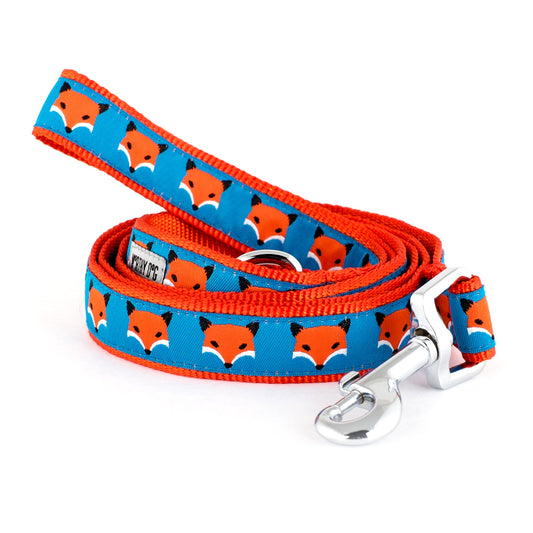 Repeating fox illustrations on blue ribbon nylon dog leash, coiled