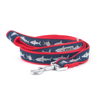 Light-colored shark silhouettes on navy ribbon nylon dog leash, coiled