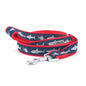 Light-colored shark silhouettes on navy ribbon nylon dog leash, coiled