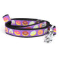 Colorful donut illustrations on purple ribbon nylon dog leash, coiled