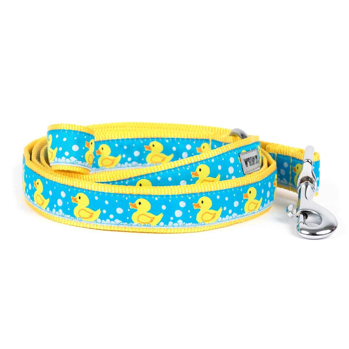 Yellow rubber-duck illustrations on blue ribbon nylon dog leash, coiled
