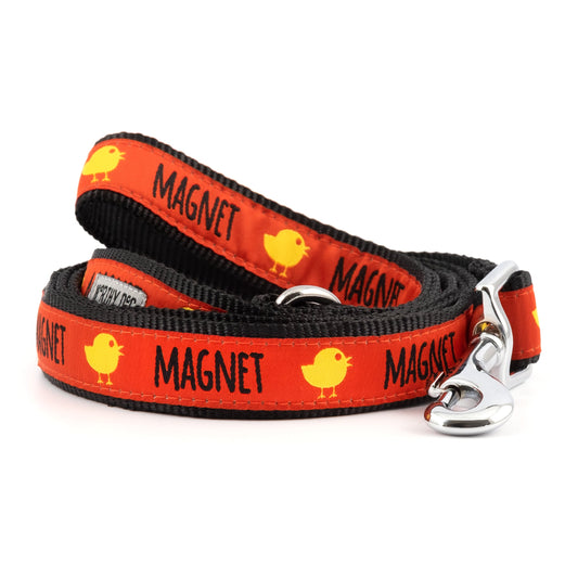 Yellow chicks and MAGNET lettering on red ribbon nylon dog leash, coiled