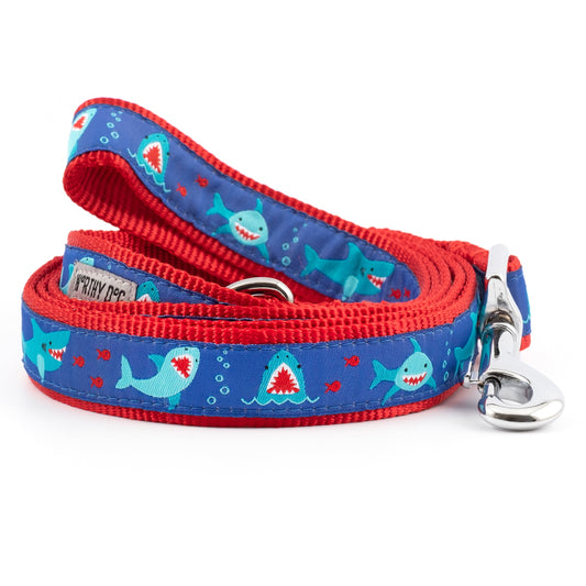 Sharks and open shark mouths on blue ribbon nylon dog leash, coiled