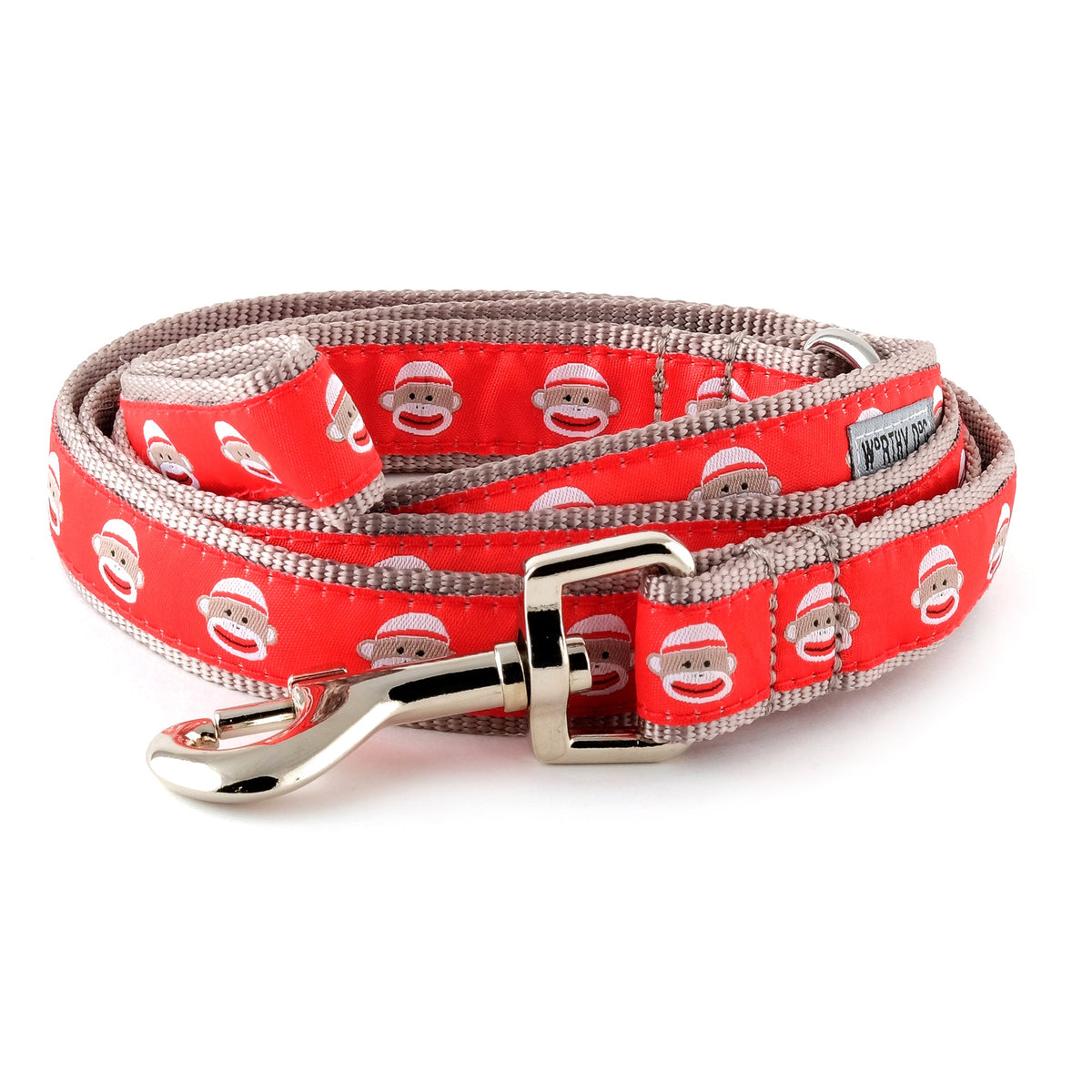 Sock-monkey illustrations on red ribbon nylon dog leash, coiled