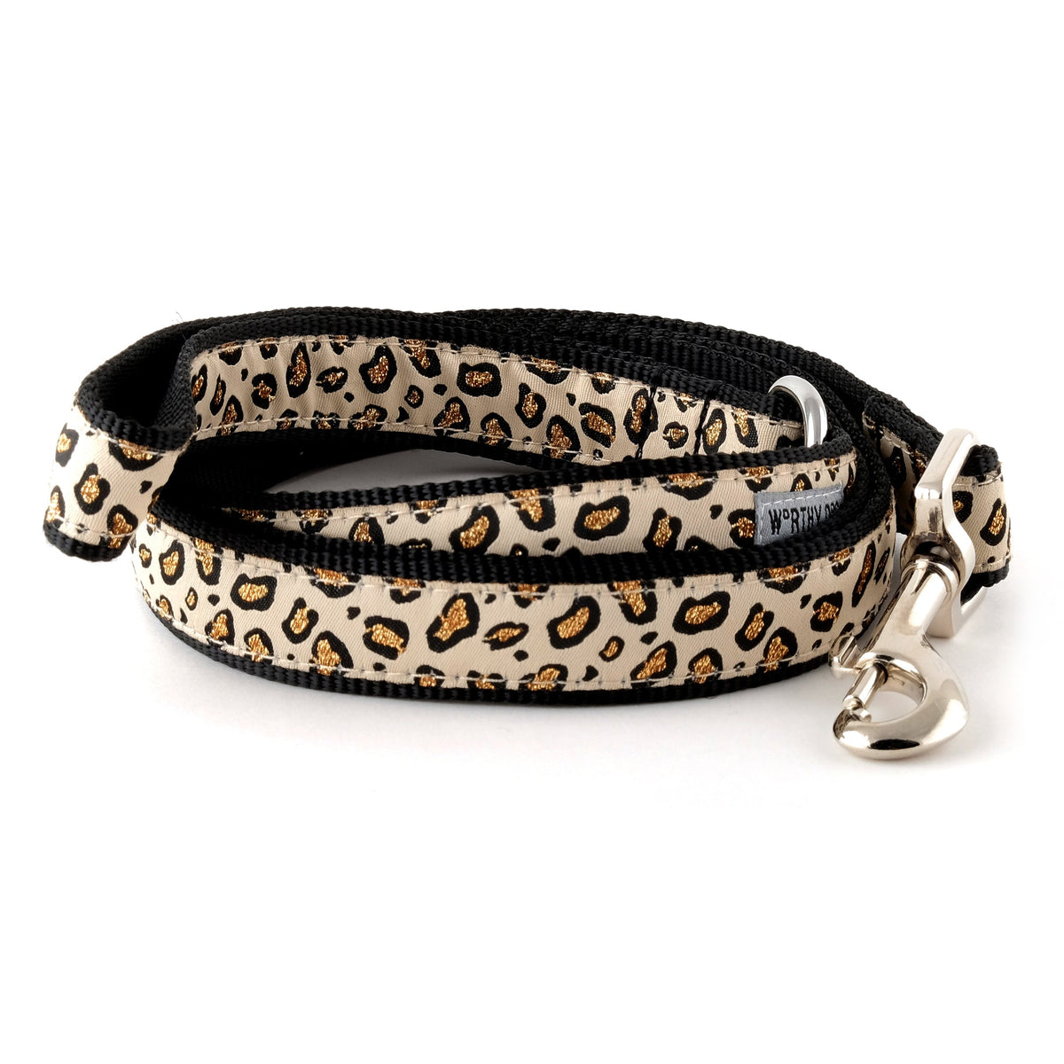 Dark animal-print spots on tan ribbon nylon dog leash, coiled