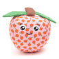Peach Squeaky Dog Toy with Green Leaf, front view with smiling face