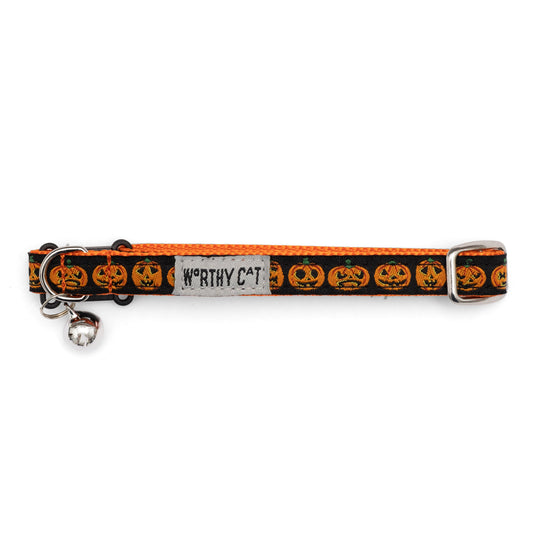 Orange jack-o-lantern faces on black ribbon Halloween cat collar, buckle and bell detail