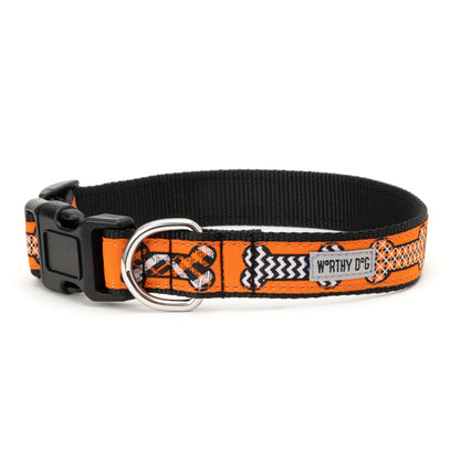 Black and white patterned bones on orange ribbon Halloween dog collar, side view