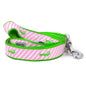 Green alligators over diagonal pink and white stripes nylon dog leash, coiled