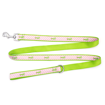 Green alligators over diagonal pink and white stripes nylon dog leash, ribbon and green backing detail