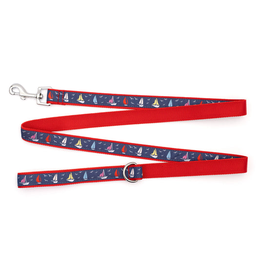 Repeating sailboat illustrations on navy ribbon nylon dog leash, ribbon and red backing detail