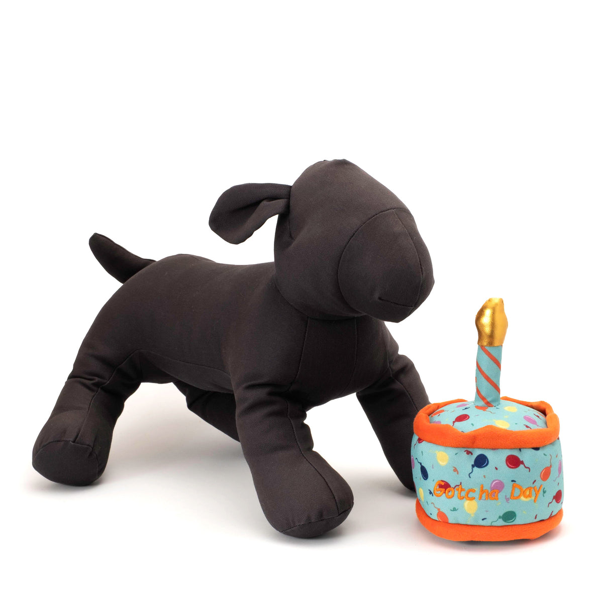Gotcha Day Cake Squeaky Dog Toy with Fabric Candle, scale beside a display dog
