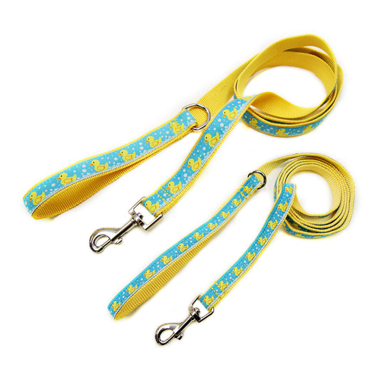 Yellow rubber-duck illustrations on blue ribbon nylon dog leash, two leash widths displayed